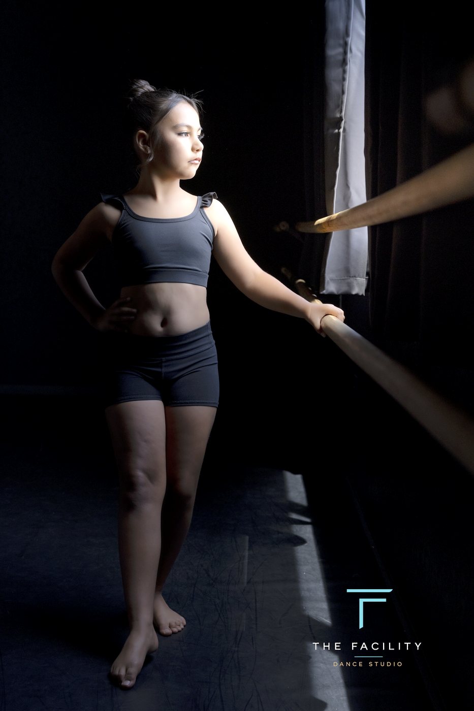 Young dancer standing tall at the barre