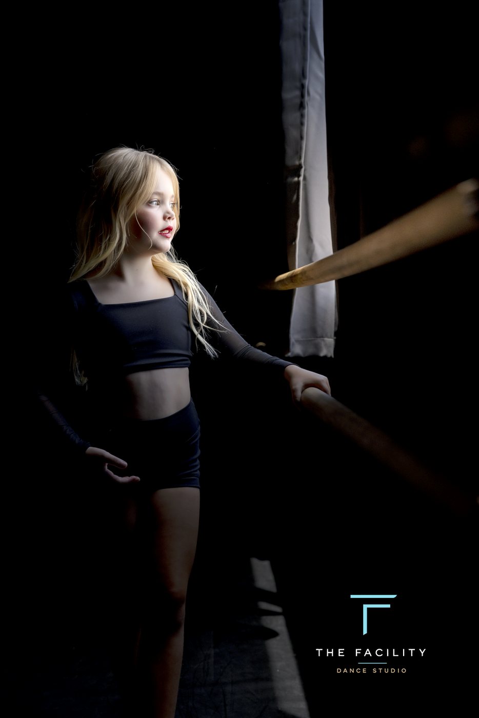 Young dancer with curls looking into the light