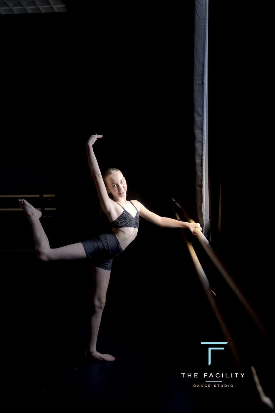 Dancer in arabesque with a leg on the barre