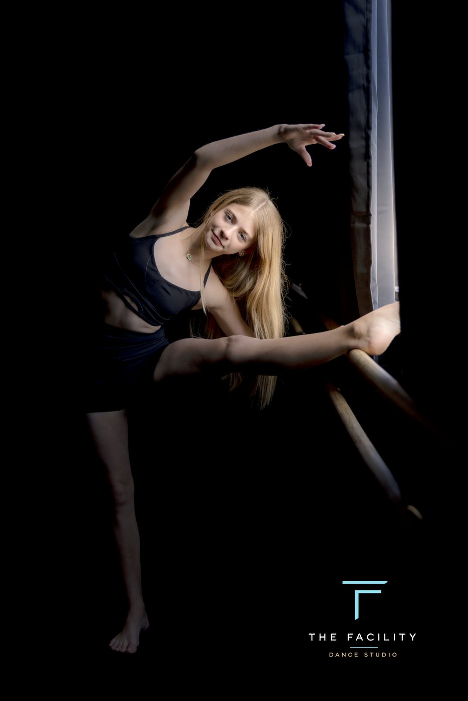 Dancer in a sculptural pose at the barre