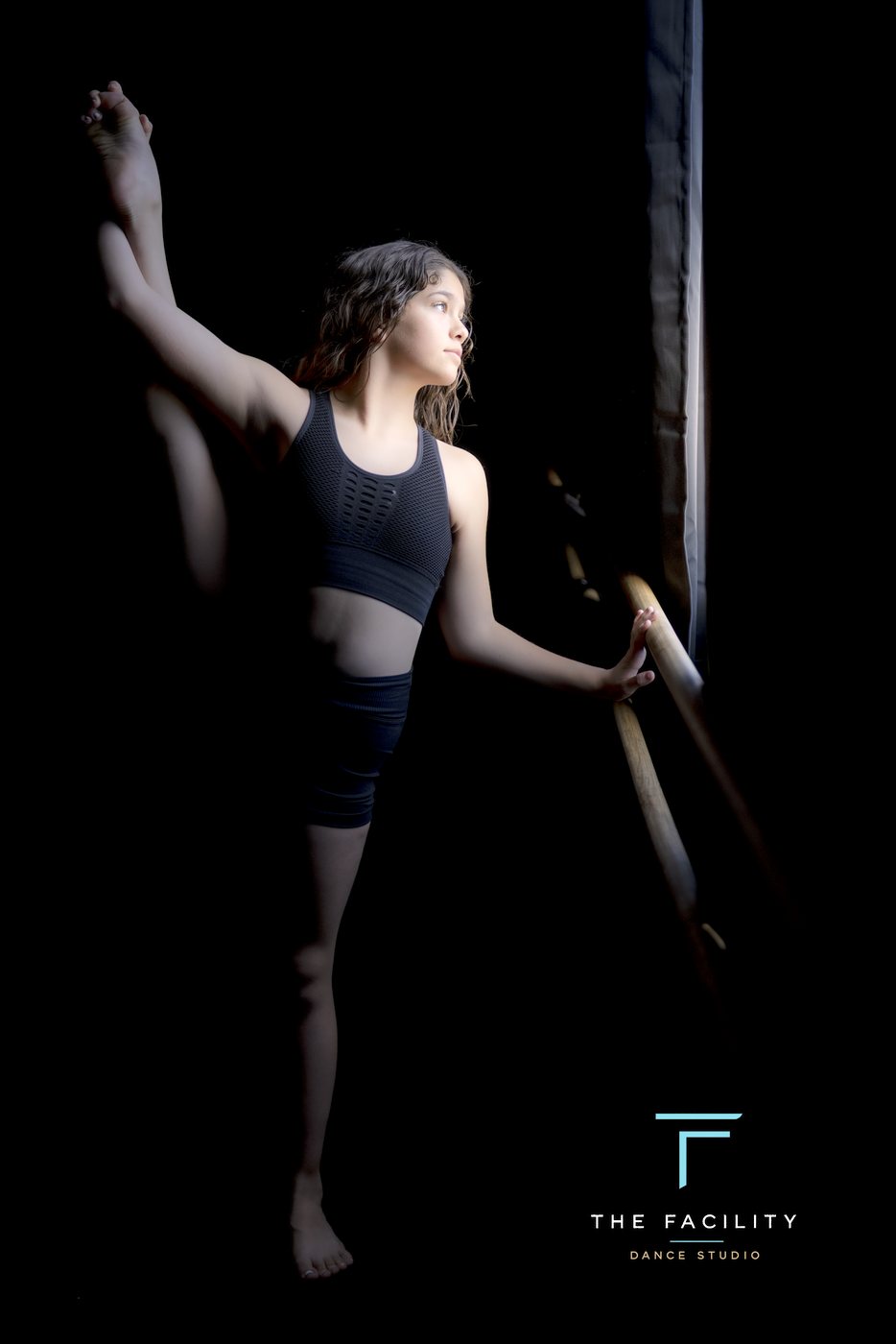 Dancer with a leg extended on the barre