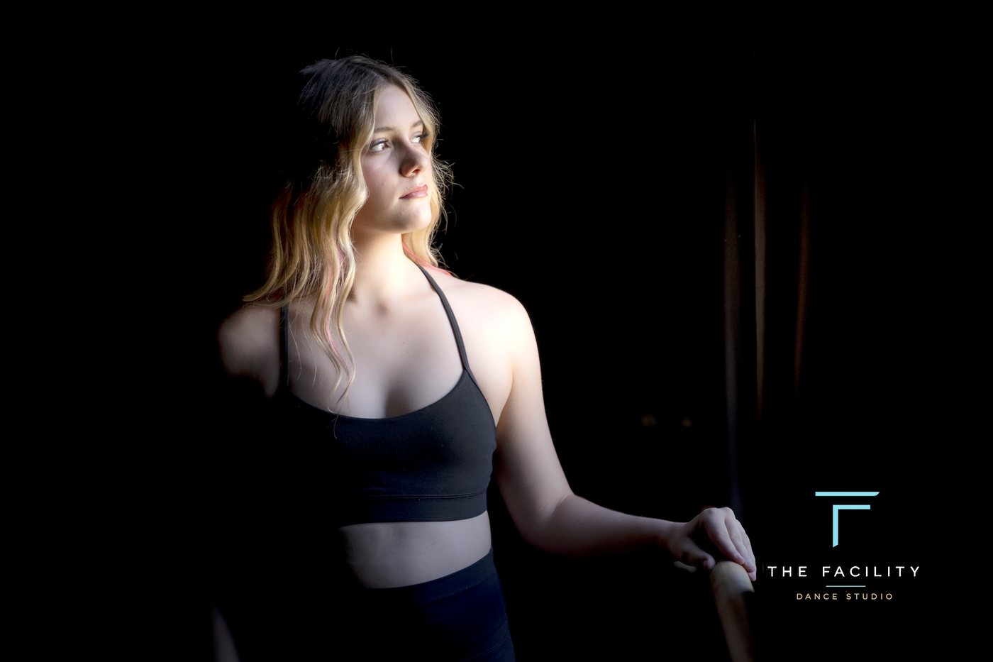 Dancer caught in a beam of window light